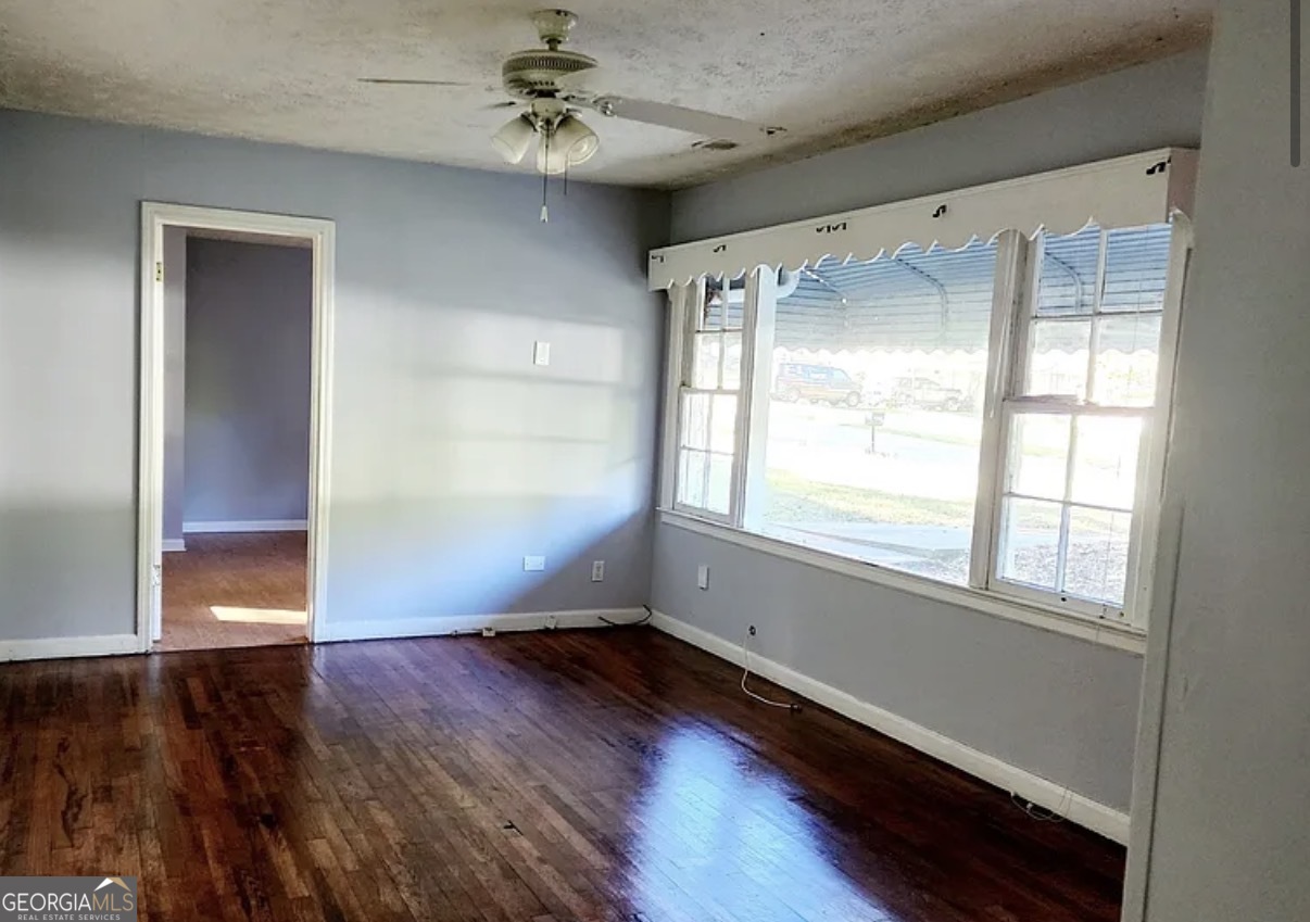 1802 Lee Street Decatur, GA 30035 - Photo 2 of 6 an empty room with wooden floor fan and windows