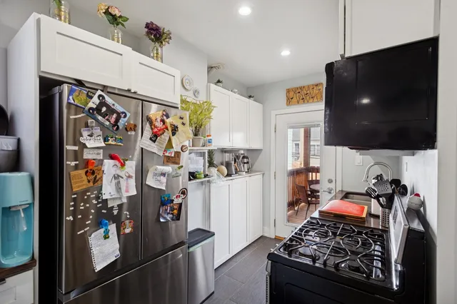 a kitchen view of a stove and refrigerator