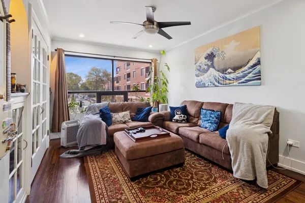 a living room with furniture a rug and a large window