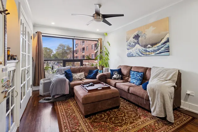 a living room with furniture a rug and a large window