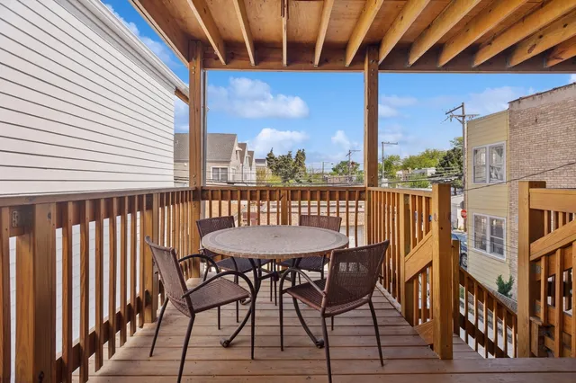 a view of a balcony with a table and chairs