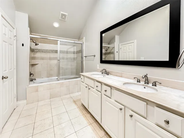 an empty room with a ceiling fan and a bathroom