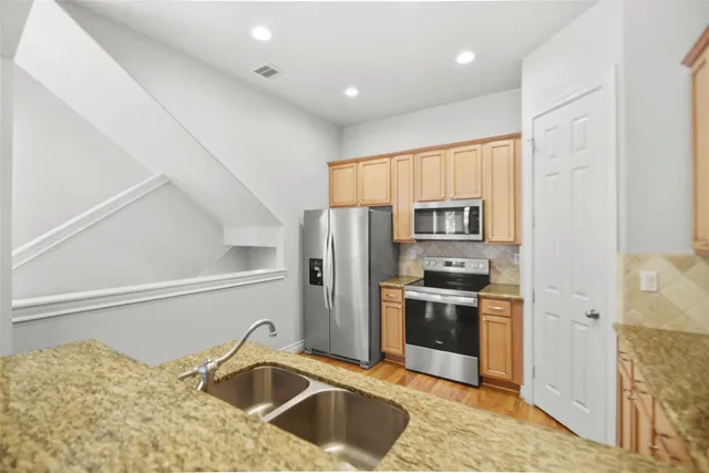a kitchen with a refrigerator sink and stove