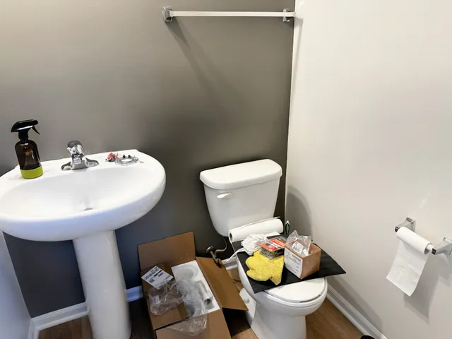 a bathroom with a toilet sink and mirror