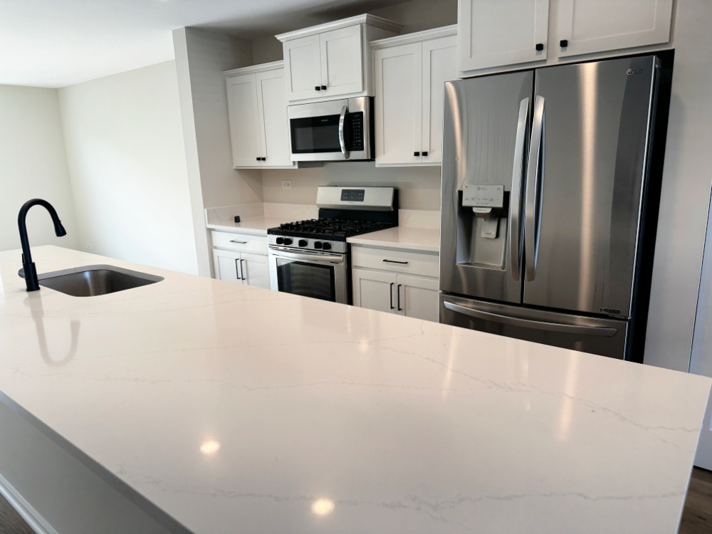 208 Goldenrod Drive, Unit 1 Elgin, IL 60124 - Photo 2 of 17 a kitchen with stainless steel appliances a refrigerator sink and microwave