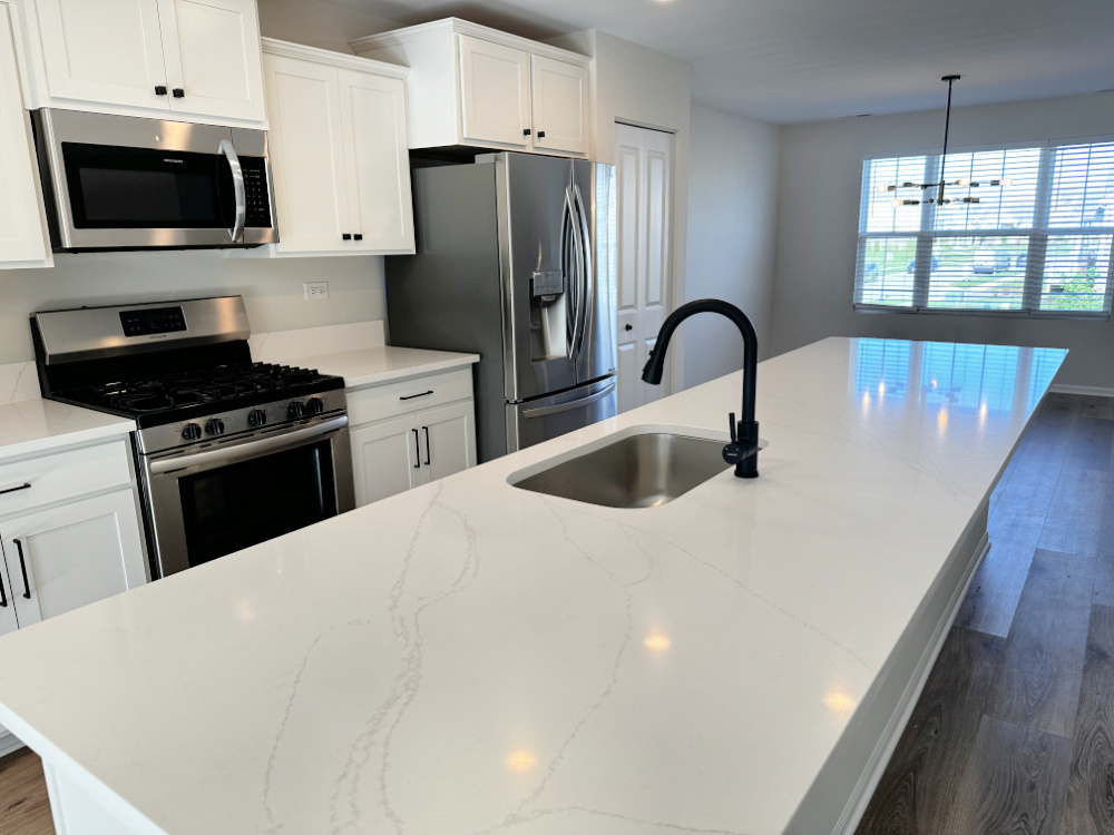 208 Goldenrod Drive, Unit 1 Elgin, IL 60124 - Photo 3 of 17 a kitchen with stainless steel appliances a stove a sink a microwave a refrigerator and cabinets
