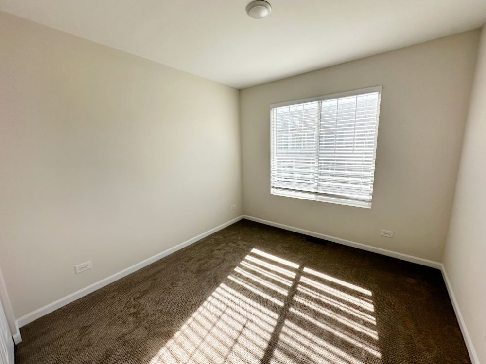 208 Goldenrod Drive, Unit 1 Elgin, IL 60124 - Photo 7 of 17 a view of an empty room with a window