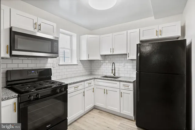 a kitchen with a refrigerator stove and microwave
