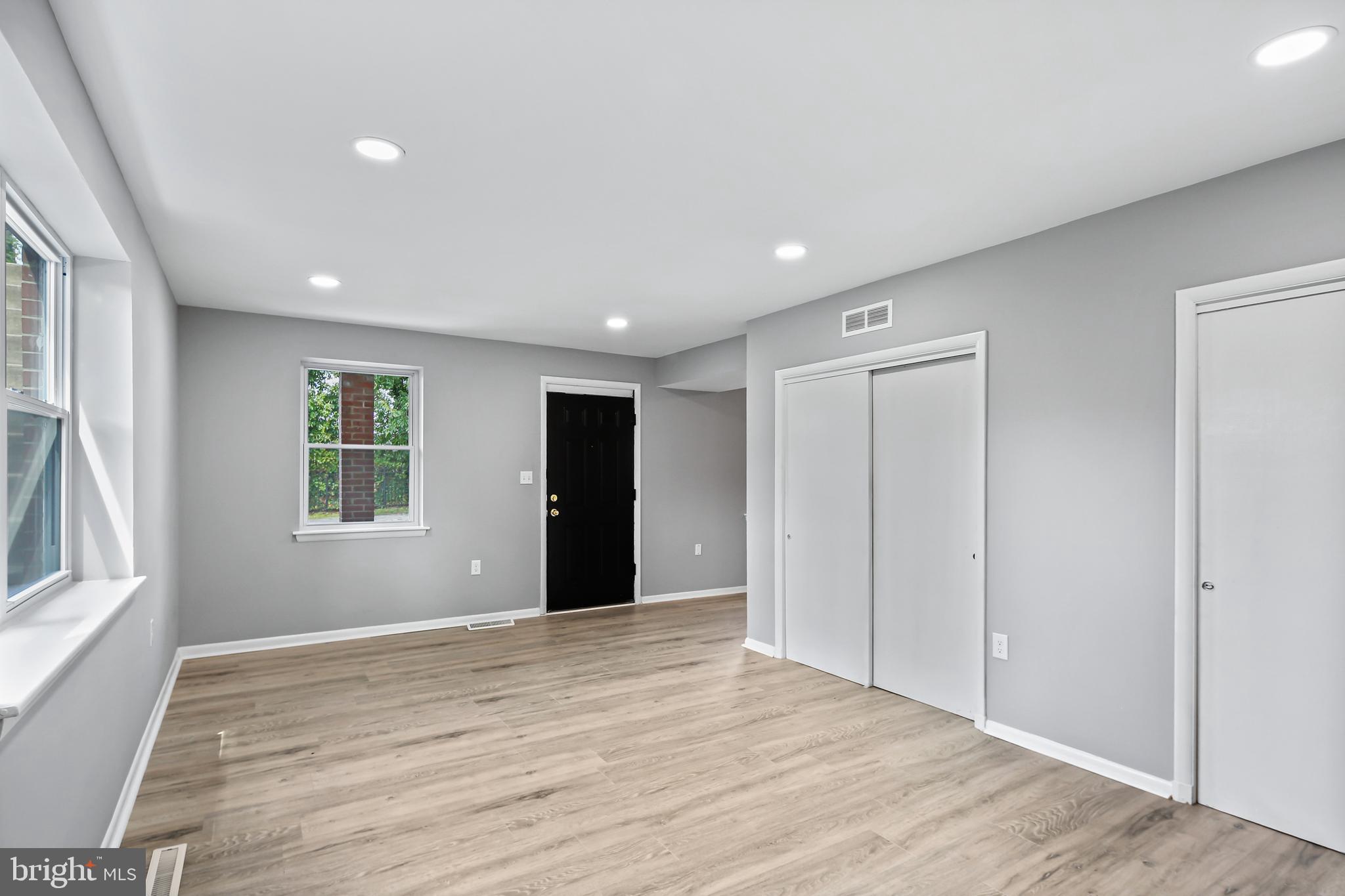 5636 Purdue Avenue Baltimore, MD 21239 - Photo 16 of 39 a view of an empty room with wooden floor and a window