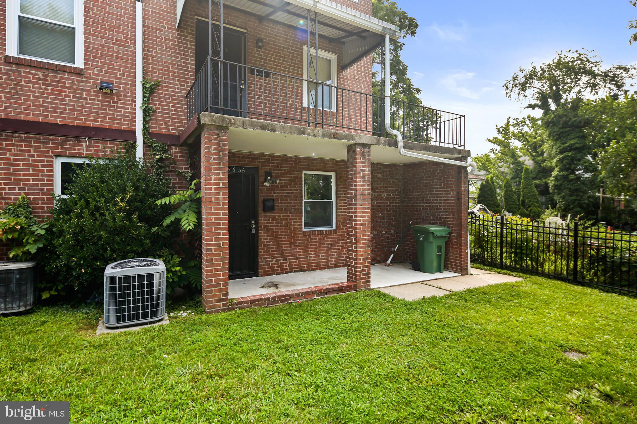 5636 Purdue Avenue Baltimore, MD 21239 - Photo 4 of 39 a front view of a house with a yard