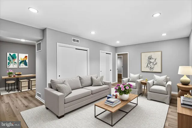 a living room with furniture and wooden floor