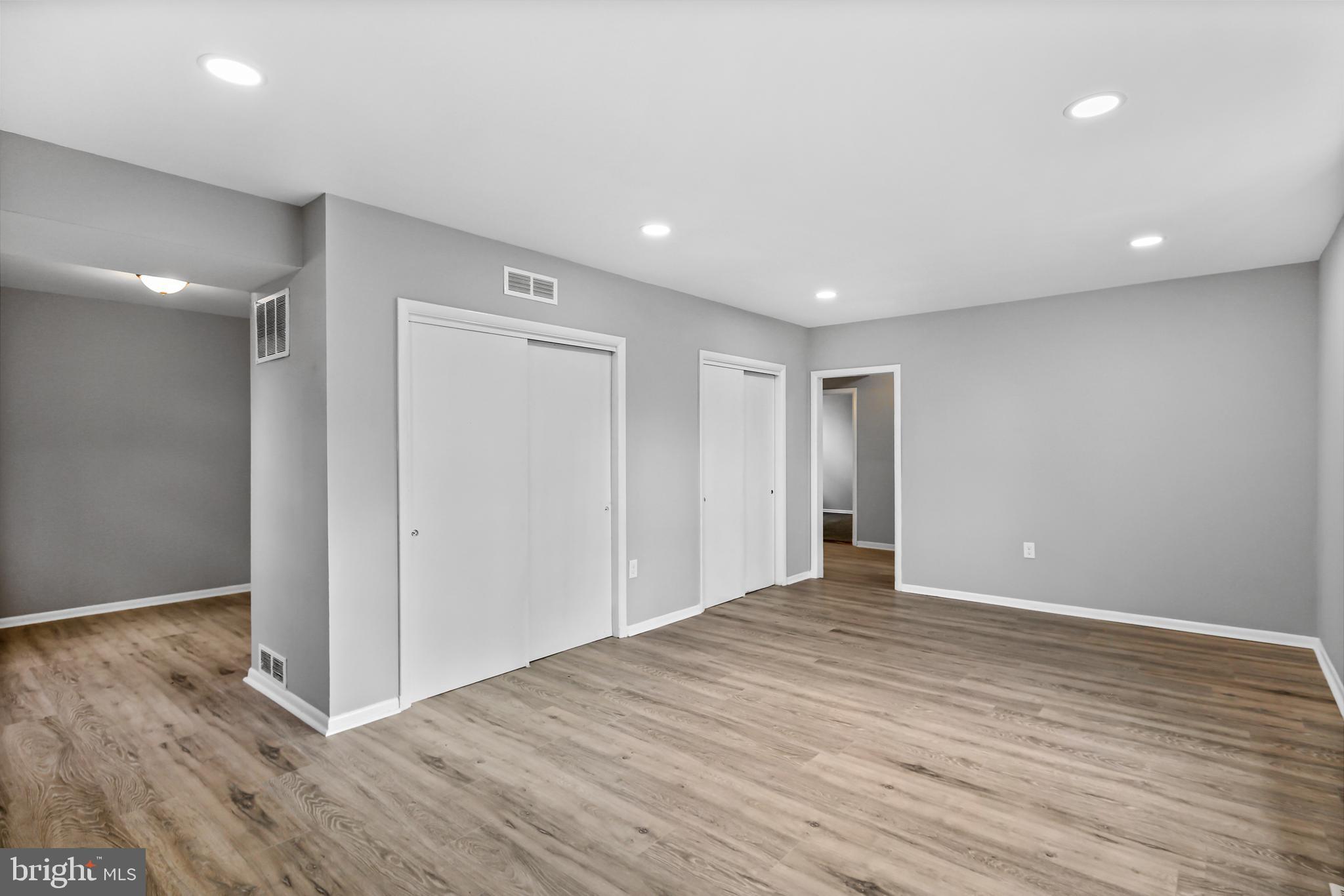 5636 Purdue Avenue Baltimore, MD 21239 - Photo 7 of 39 a view of an empty room with wooden floor