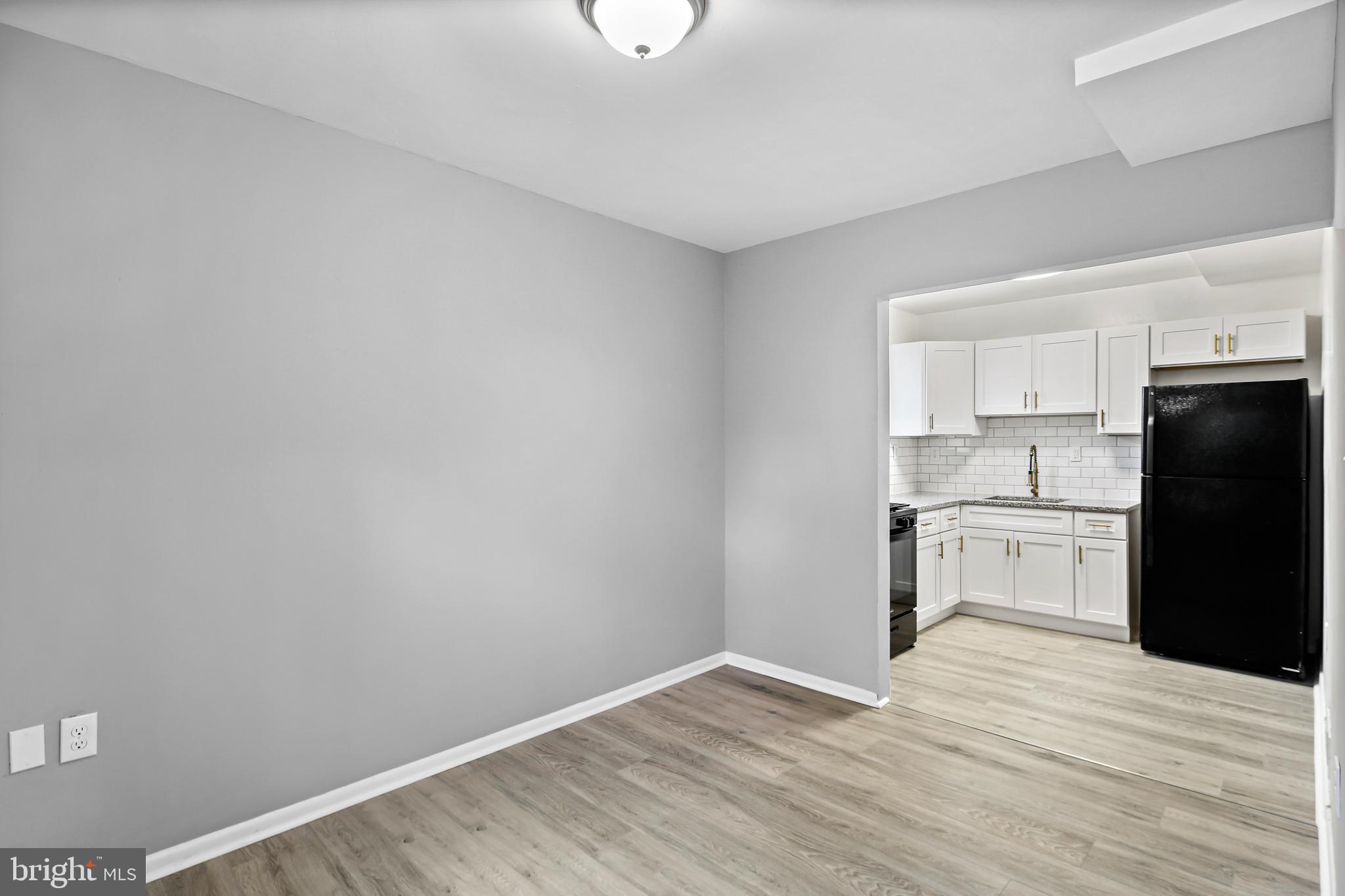 5636 Purdue Avenue Baltimore, MD 21239 - Photo 9 of 39 a kitchen with a refrigerator and a stove top oven