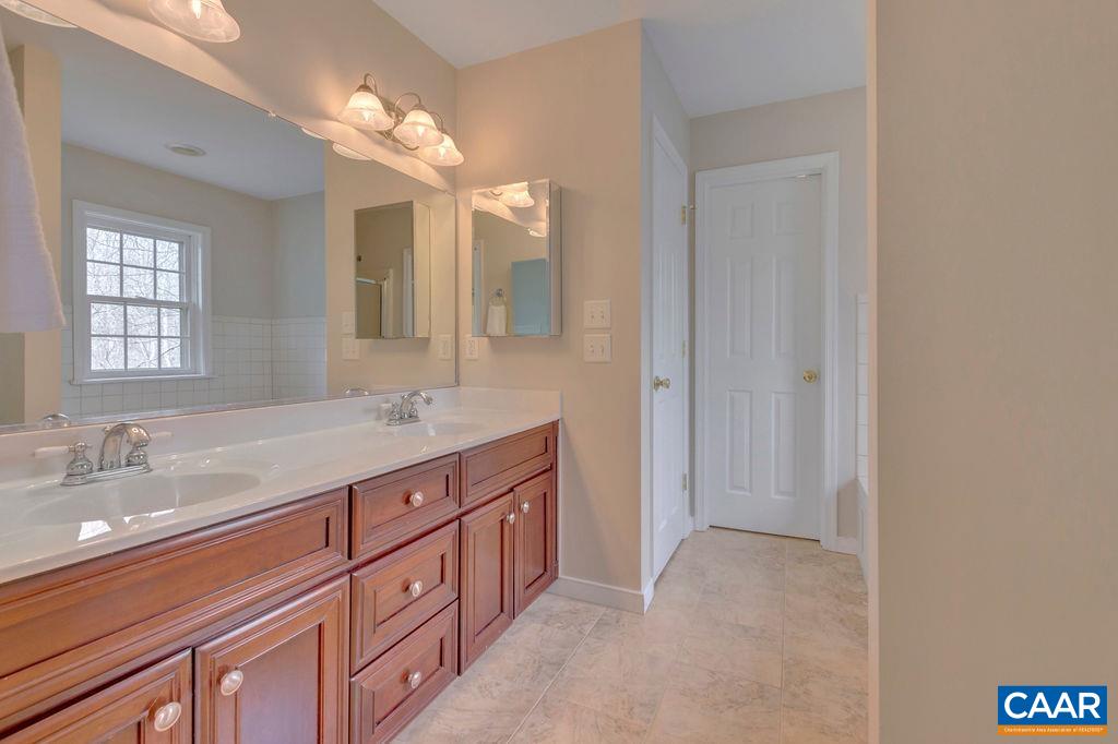 320 Starcrest Road Charlottesville, VA 22902 - Photo 29 of 38 a spacious bathroom with a granite countertop sink a mirror and a
