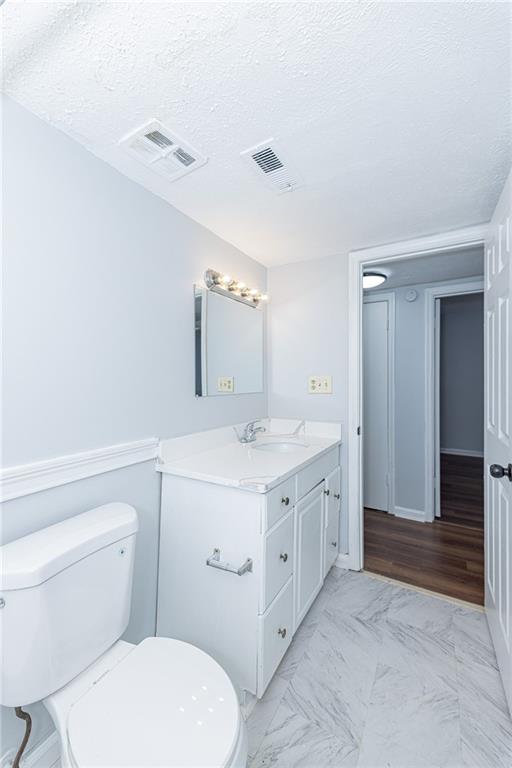 2398 Lawrenceville Highway, Unit U Decatur, GA 30033 - Photo 17 of 32 a spacious bathroom with a granite countertop toilet sink and mirror