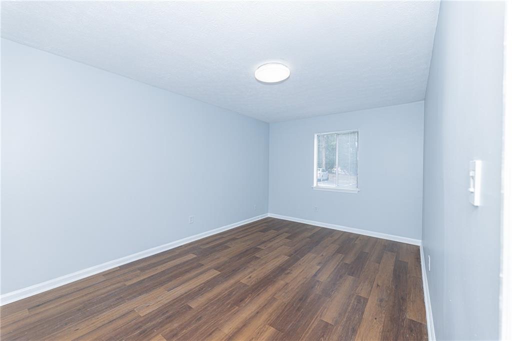 2398 Lawrenceville Highway, Unit U Decatur, GA 30033 - Photo 19 of 32 an empty room with wooden floor and windows