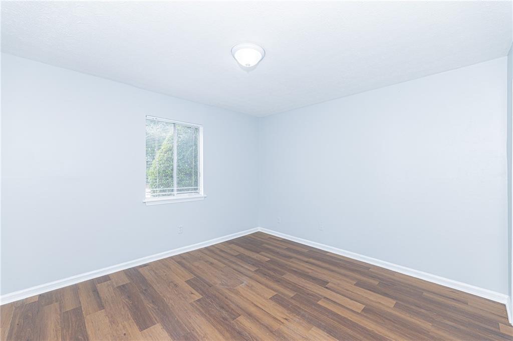 2398 Lawrenceville Highway, Unit U Decatur, GA 30033 - Photo 24 of 32 an empty room with wooden floor and windows