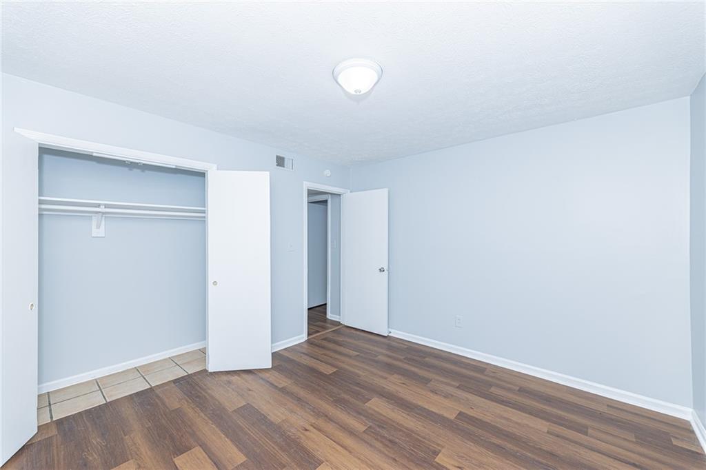 2398 Lawrenceville Highway, Unit U Decatur, GA 30033 - Photo 25 of 32 a view of an empty room with wooden floor and a window