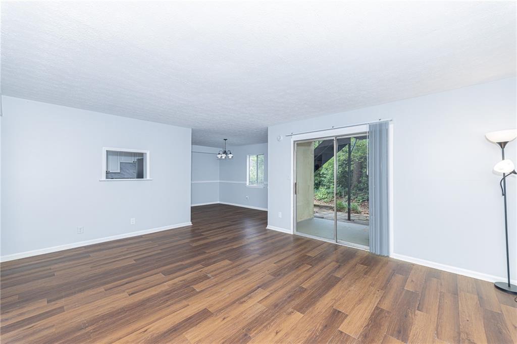 2398 Lawrenceville Highway, Unit U Decatur, GA 30033 - Photo 5 of 32 an empty room with wooden floor and windows
