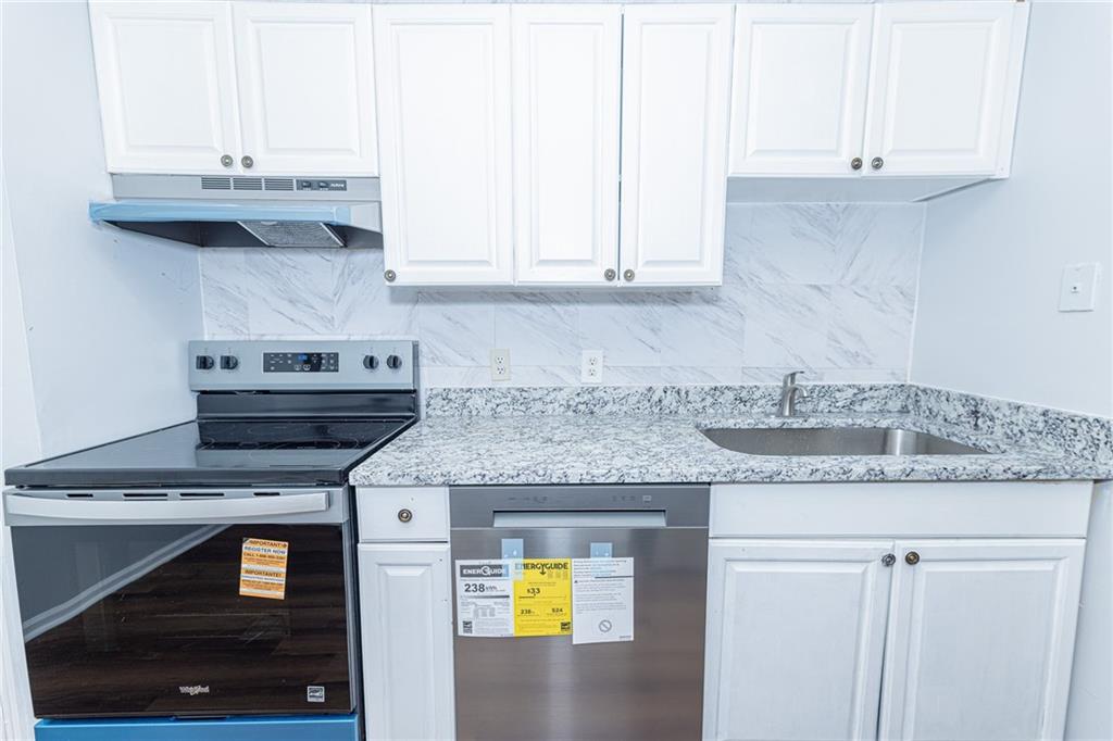 2398 Lawrenceville Highway, Unit U Decatur, GA 30033 - Photo 10 of 32 a kitchen with stainless steel appliances granite countertop a sink a stove and a white cabinets