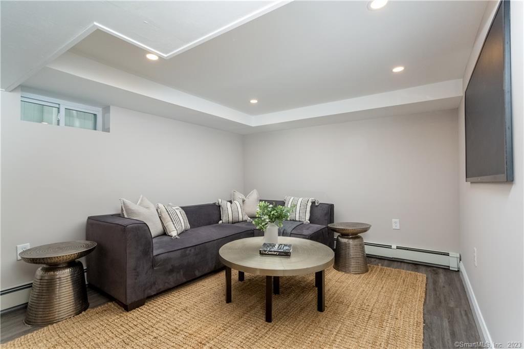 1748 Stratfield Road Fairfield, CT 06825 - Photo 27 of 30 a living room with furniture and a wooden floor