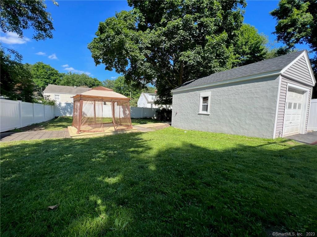 1748 Stratfield Road Fairfield, CT 06825 - Photo 28 of 30 a view of a house with a backyard porch and sitting area