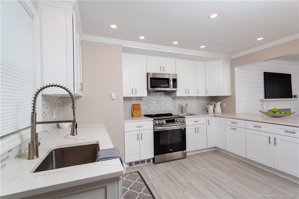 1748 Stratfield Road Fairfield, CT 06825 - Photo 9 of 30 a kitchen with sink a microwave and cabinets