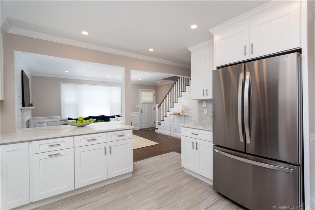 1748 Stratfield Road Fairfield, CT 06825 - Photo 10 of 30 a kitchen with white cabinets and white appliances