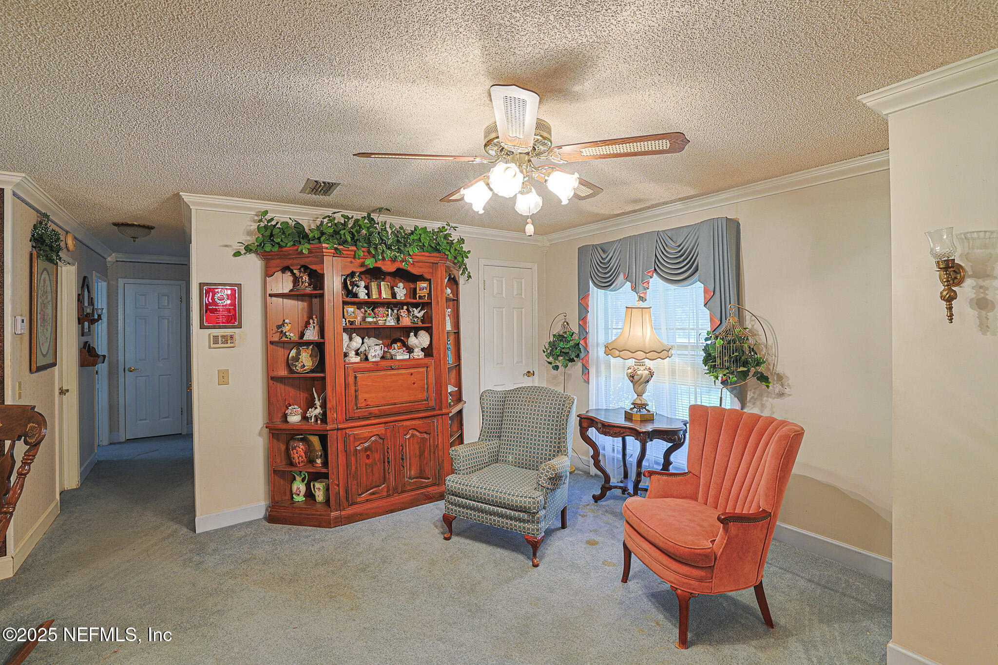 1610 Rivers Road Green Cove Springs, FL 32043 - Photo 15 of 64 a view of a livingroom with furniture and a ceiling fan