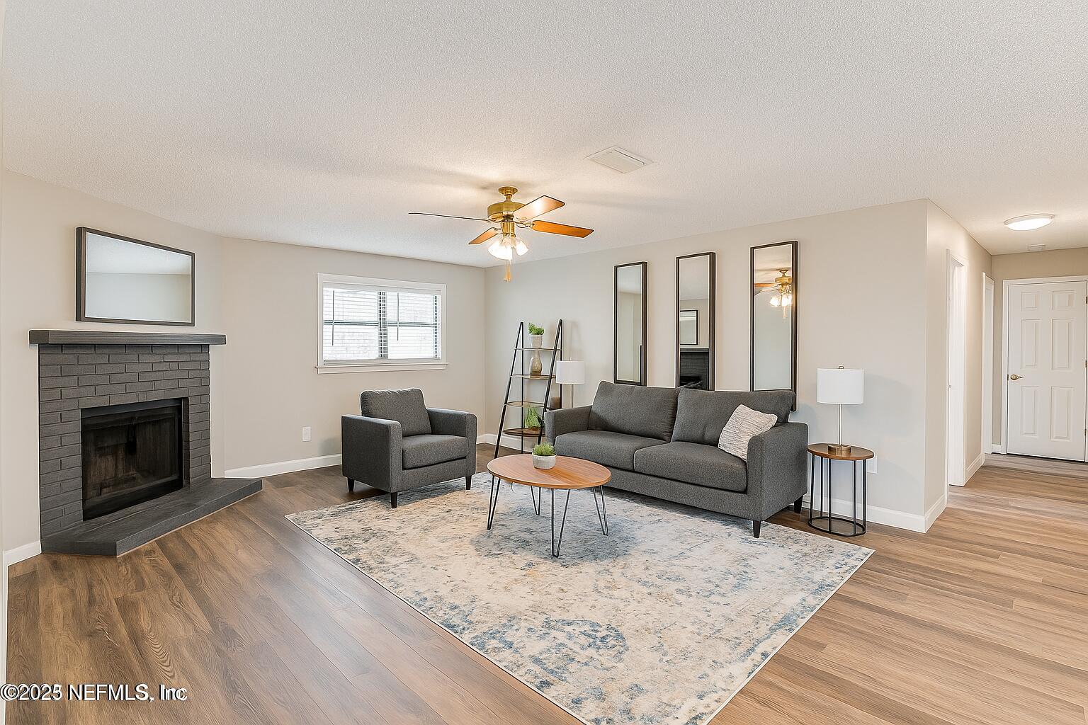 1610 Rivers Road Green Cove Springs, FL 32043 - Photo 20 of 64 a living room with furniture and a fireplace