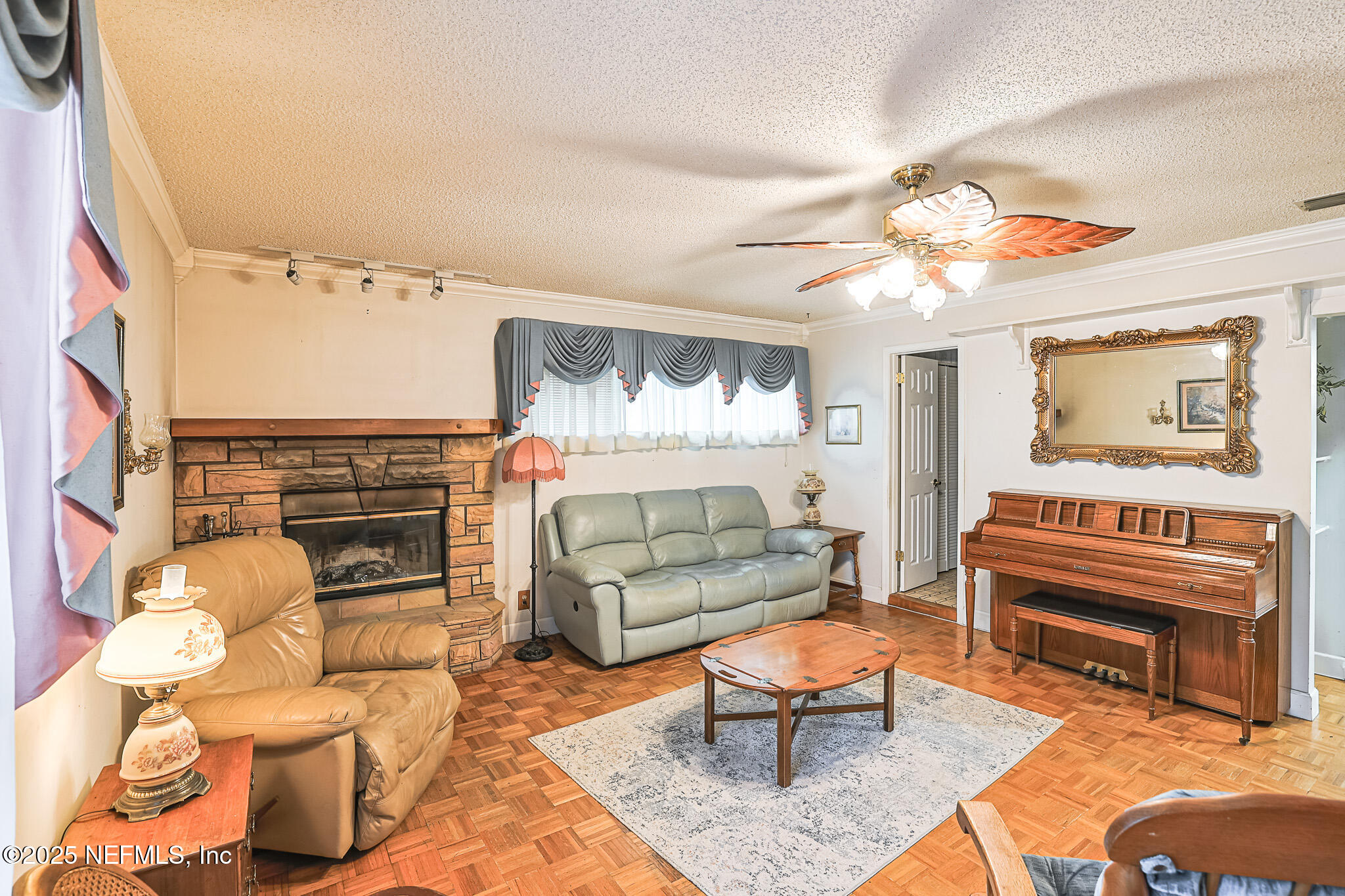 1610 Rivers Road Green Cove Springs, FL 32043 - Photo 26 of 64 a living room with furniture and a fireplace