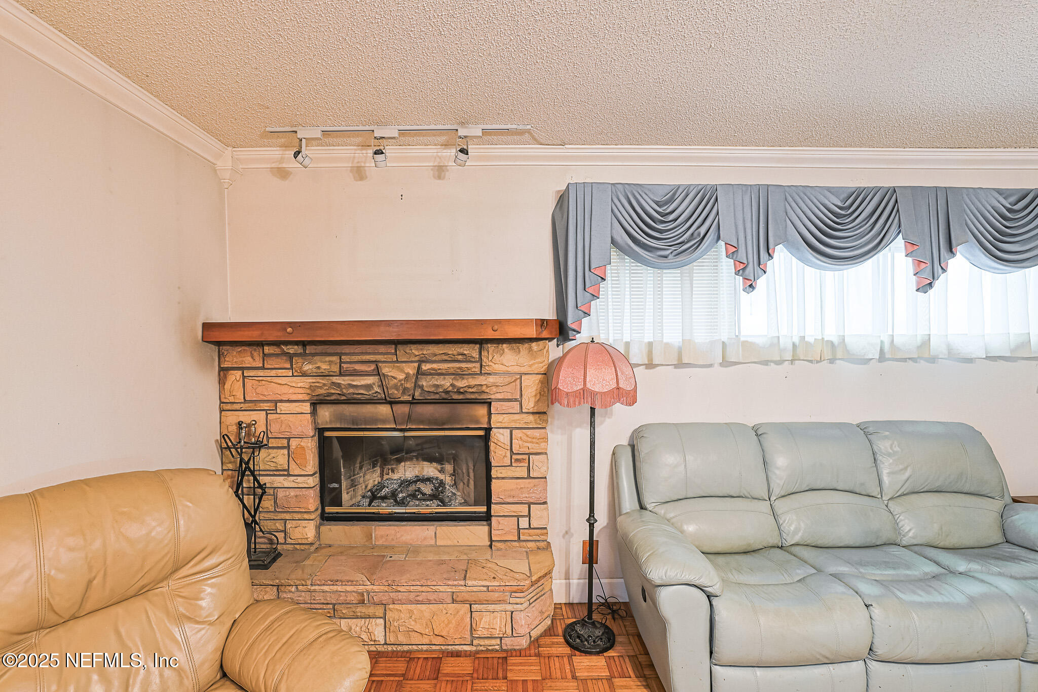 1610 Rivers Road Green Cove Springs, FL 32043 - Photo 28 of 64 a living room with a couch and a fireplace