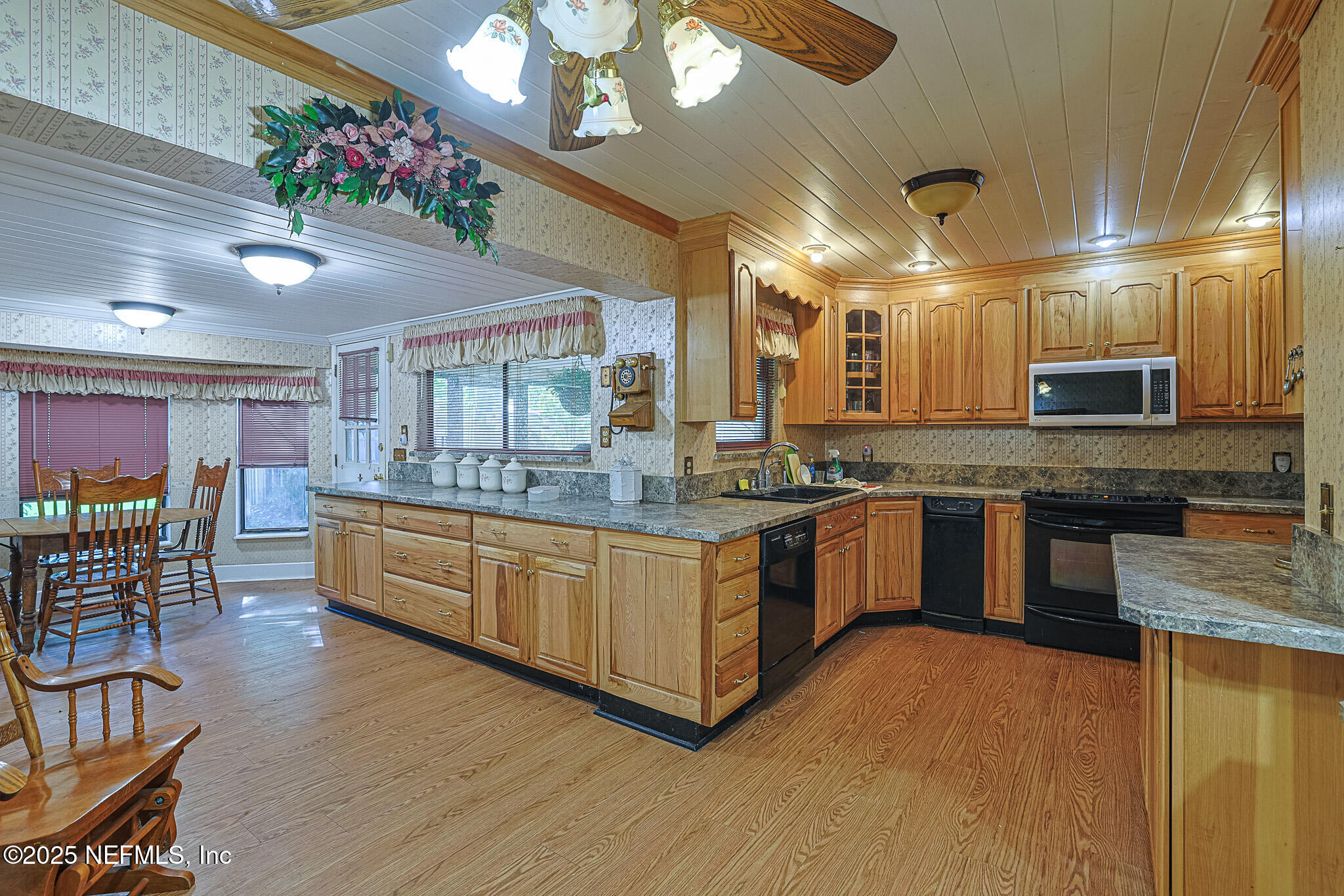 1610 Rivers Road Green Cove Springs, FL 32043 - Photo 34 of 64 a large kitchen with a large island in the center a sink stainless steel appliances and cabinets