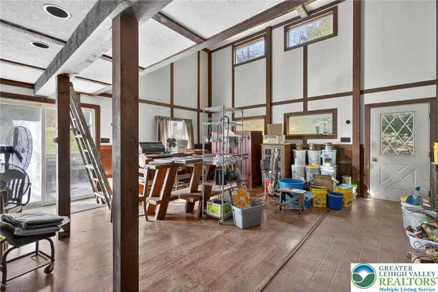 a kitchen with a refrigerator a table and chairs
