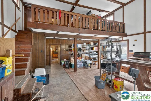 a dining room with a wooden table and chairs