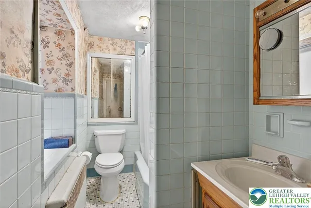 a view of a dining room with furniture a chandelier and wooden floor