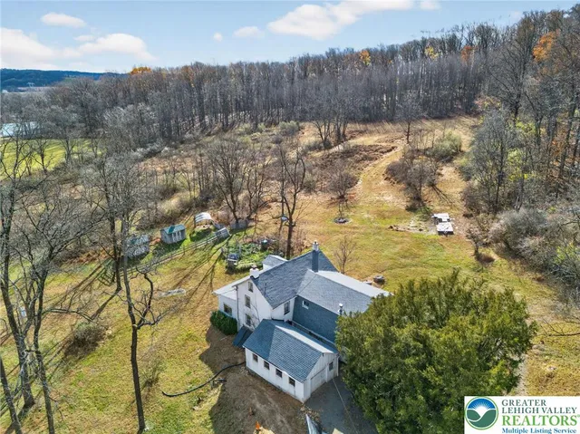 a view of a house with a yard and wooden fence