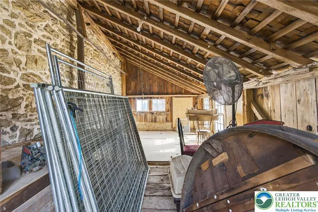a view of swimming pool with a bench and trees in the background