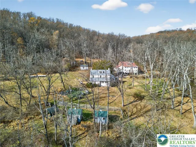 a view of a house with a yard covered in snow