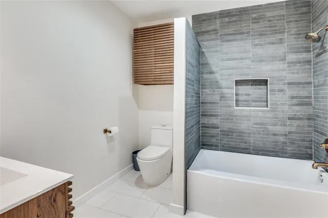 a bathroom with a bathtub and toilet
