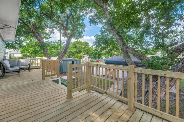 a view of a deck with chairs and wooden fence