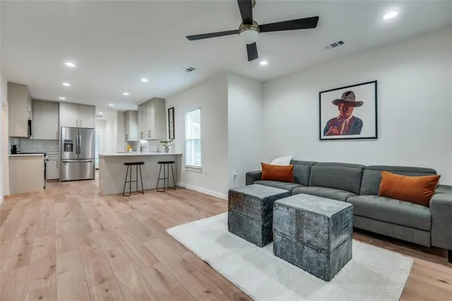 a living room with furniture and kitchen view