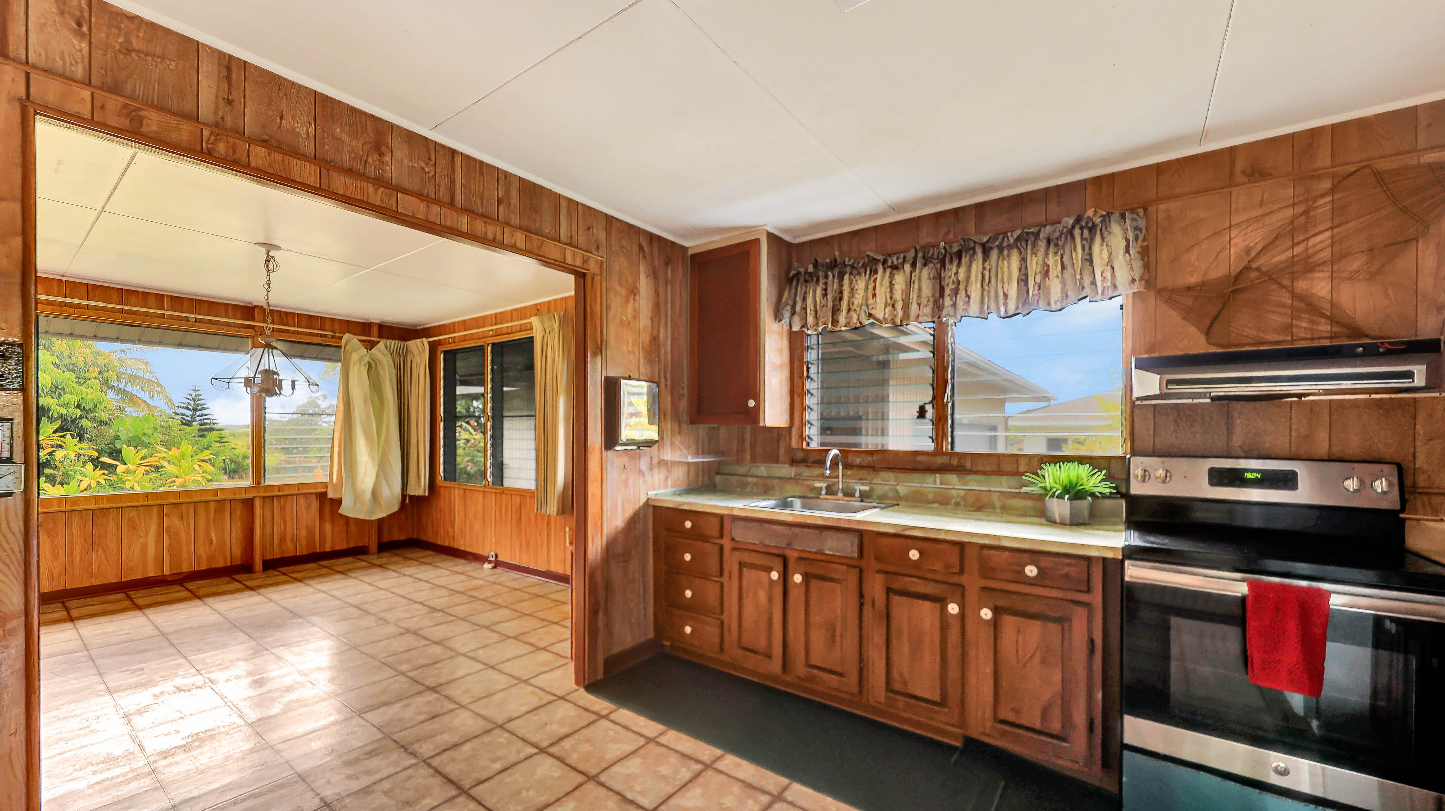 5116 Kula Road Kapaa, HI 96746 - Photo 17 of 28 a kitchen with stainless steel appliances granite countertop a stove a sink and a microwave