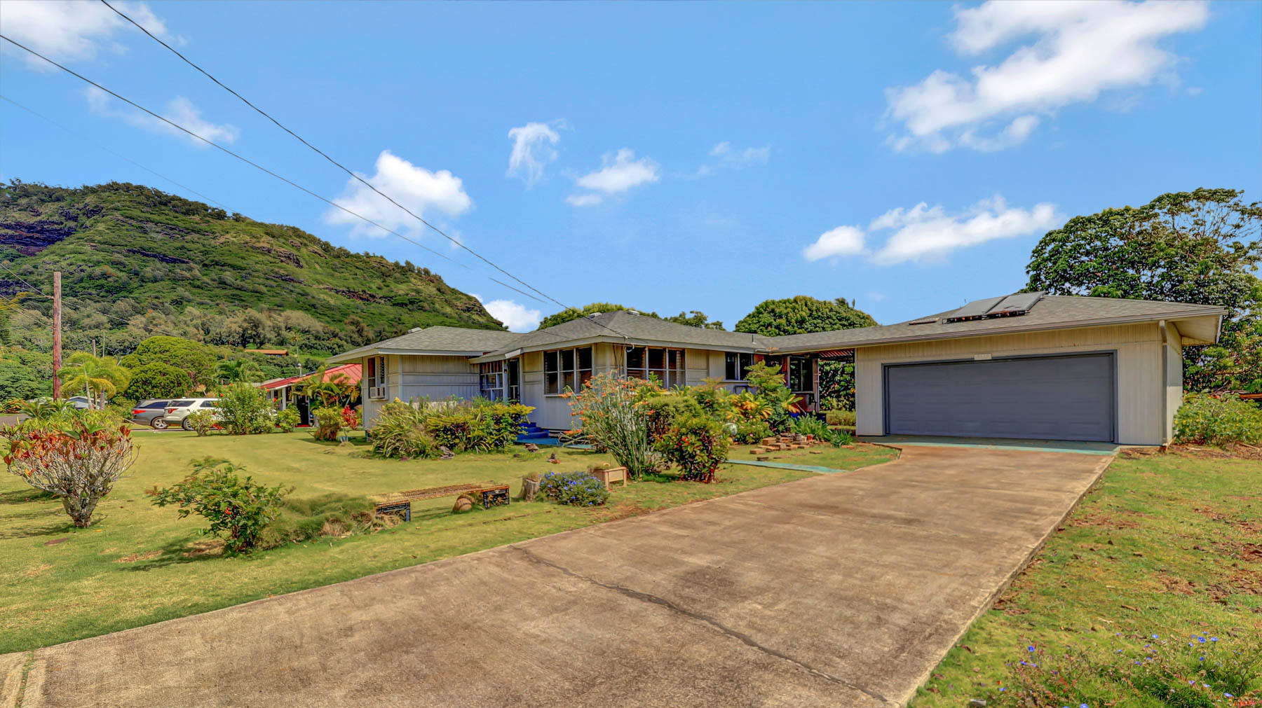 5116 Kula Road Kapaa, HI 96746 - Photo 9 of 28 a front view of a house with a yard and garage