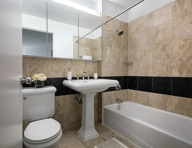 a bathroom with a sink a toilet and bathtub