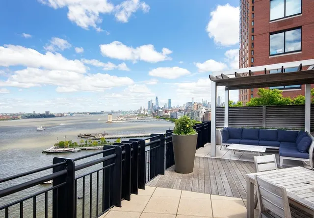 a view of a terrace with wooden floor and lake view