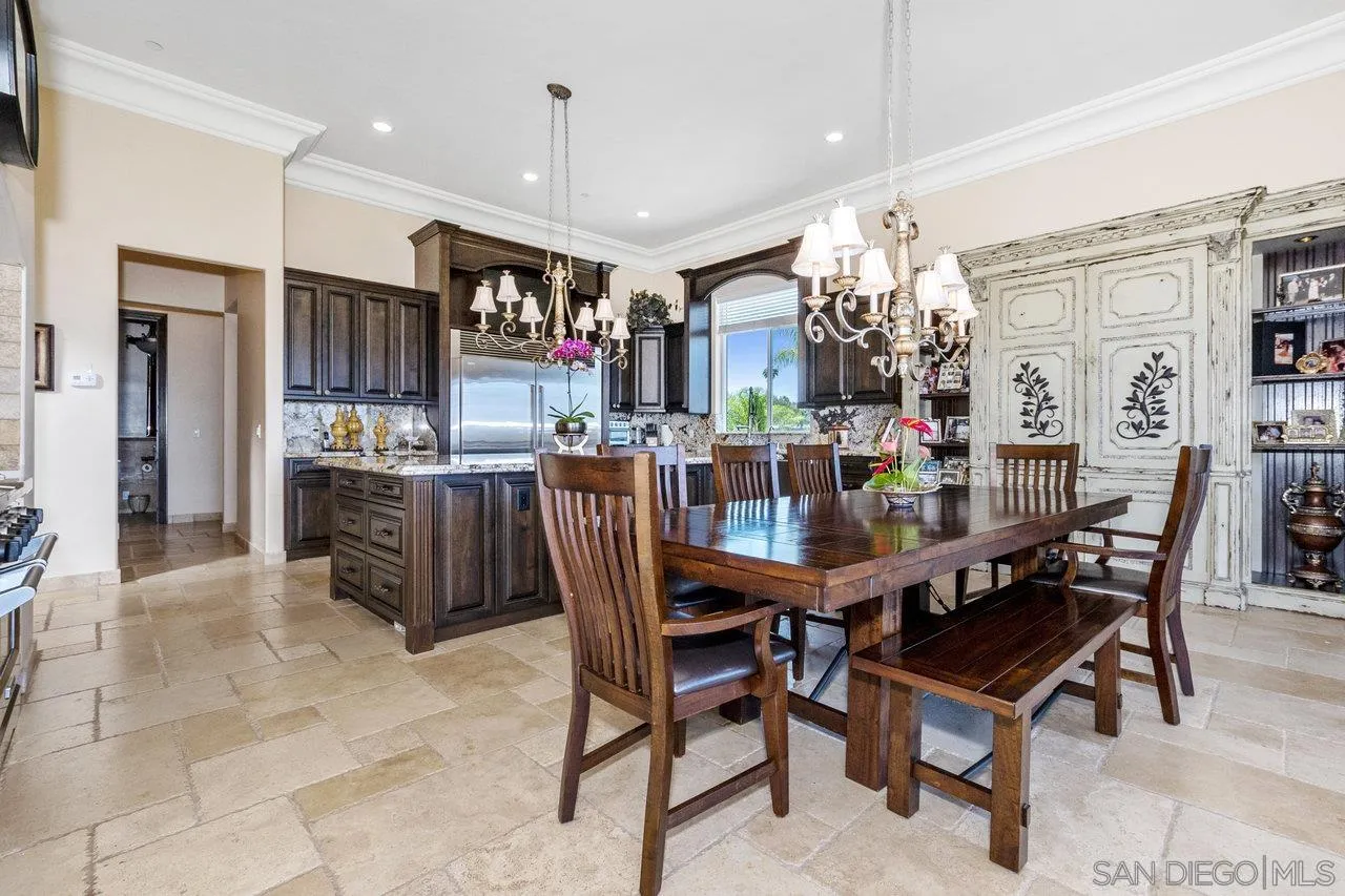 7342 Altiva Place Carlsbad, CA 92009 - Photo 13 of 56 a dining hall with stainless steel appliances granite countertop a dining table and chairs