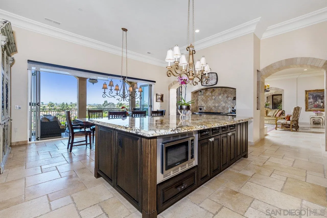 7342 Altiva Place Carlsbad, CA 92009 - Photo 15 of 56 a kitchen with stainless steel appliances granite countertop a sink and cabinets