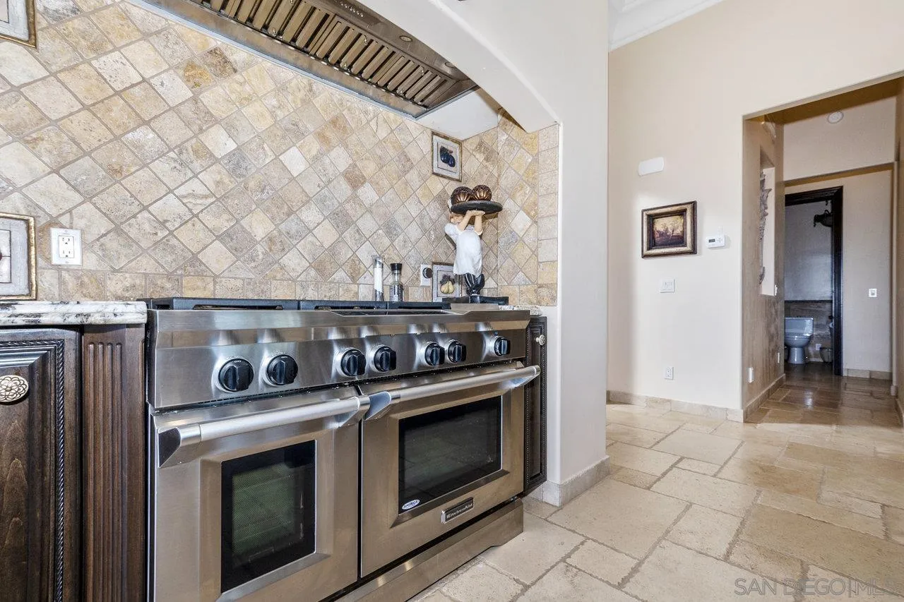 7342 Altiva Place Carlsbad, CA 92009 - Photo 16 of 56 a stove top oven sitting inside of a kitchen