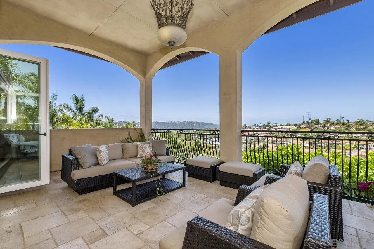 7342 Altiva Place Carlsbad, CA 92009 - Photo 21 of 56 a living room with furniture and a floor to ceiling window